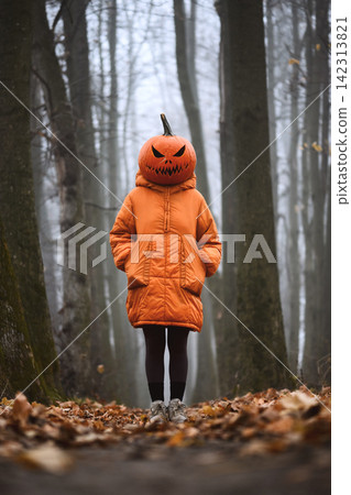 Person wearing an orange coat and carved pumpkin head Person wearing an orange coat and carved pumpkin head 142313821
