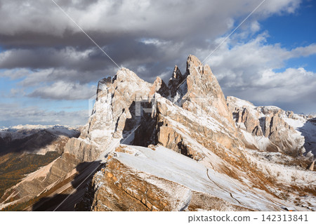 Snow-covered Seceda peaks illuminated by sunlight beneath Snow-covered Seceda peaks illuminated by sunlight beneath 142313841