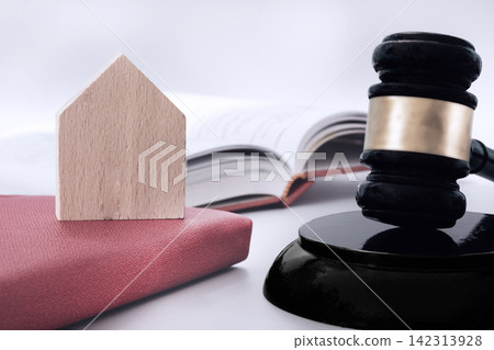 Wooden house, judge gavel and books with white background on table. Asset forfeiture, foreclosure and real-estate law concept Wooden house, judge gavel and books with white background on table. Asset forfeiture, foreclosure and real-estate law concept 142313928