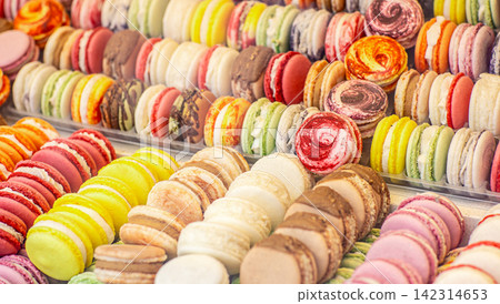 Colorful french macarons assortment displayed at dessert market stall Colorful french macarons assortment displayed at dessert market stall 142314653