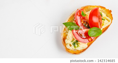 Open-faced sandwich topped with fresh tomatoes, basil leaves, and creamy spread on toasted bread, presented on a clean white background for culinary display. space for text Open-faced sandwich topped with fresh tomatoes, basil leaves, and creamy spread on toasted bread, presented on a clean white background for culinary display. space for text 142314685