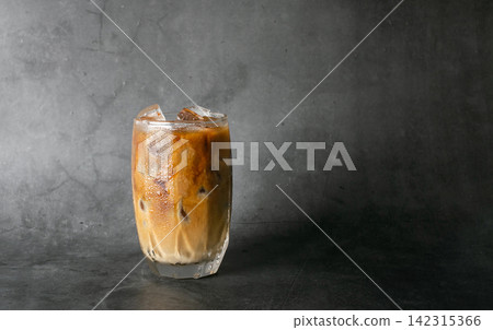 iced latte coffee into a transparent glass with ice on black background studio photo. Copy four text iced latte coffee into a transparent glass with ice on black background studio photo. Copy four text 142315366
