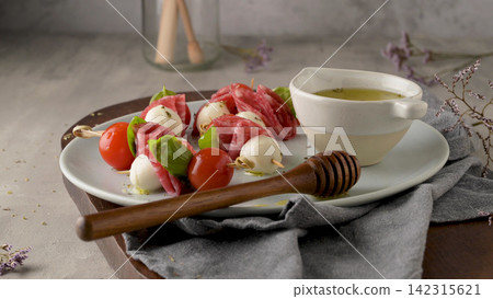 Antipasto skewers with salami, mozzarella, and cherry tomato Antipasto skewers with salami, mozzarella, and cherry tomato 142315621