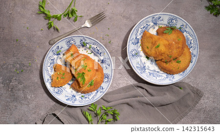 Golden fried rissoles served on vintage blue and white patterned plates Golden fried rissoles served on vintage blue and white patterned plates 142315643
