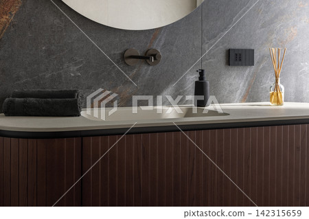 Integrated bathroom basin featuring folded towels in gentle window illumination Integrated bathroom basin featuring folded towels in gentle window illumination 142315659