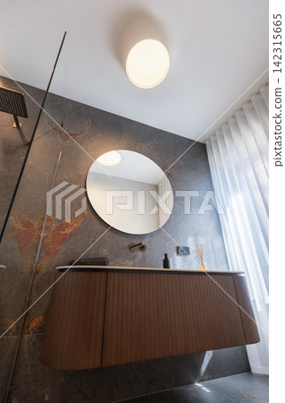 Floating bathroom vanity with round mirror under controlled side light Floating bathroom vanity with round mirror under controlled side light 142315665
