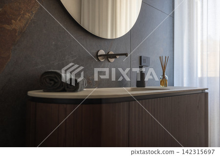 Curved bathroom vanity with fluted wood cabinet through an eye level design view 142315697