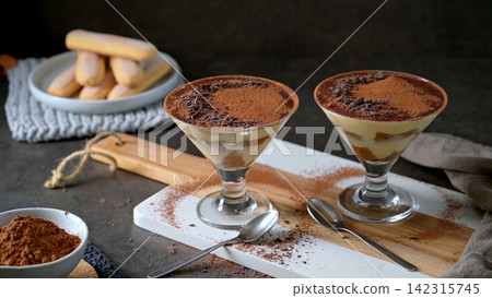 Two Glasses of Individual Tiramisu Served in stemmed cocktail Coupes Two Glasses of Individual Tiramisu Served in stemmed cocktail Coupes 142315745