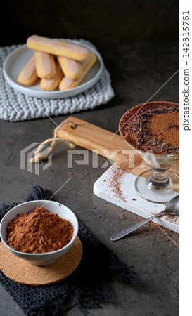 Tiramisu Ingredients with Ladyfingers and Cocoa Powder Top Down View Tiramisu Ingredients with Ladyfingers and Cocoa Powder Top Down View 142315761