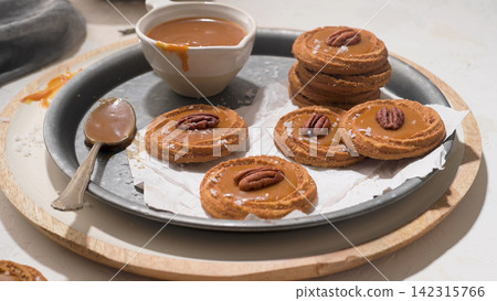 Cinnamon Pecan Cookies with Salted Caramel on a Vintage Metal Tray Cinnamon Pecan Cookies with Salted Caramel on a Vintage Metal Tray 142315766