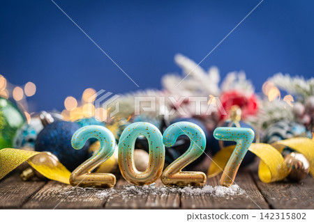 2026 New Year Candles with Christmas Ornaments on Blue 2026 New Year Candles with Christmas Ornaments on Blue 142315802