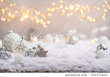 Silver and White Christmas Decorations on Snowy Surface Silver and White Christmas Decorations on Snowy Surface 142315819