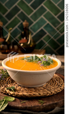 Creamy Pumpkin Soup Garnished with Fresh Spinach and Rosemary Creamy Pumpkin Soup Garnished with Fresh Spinach and Rosemary 142316006