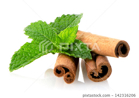 Cinnamon sticks and mint leaves Cinnamon sticks and mint leaves 142316206