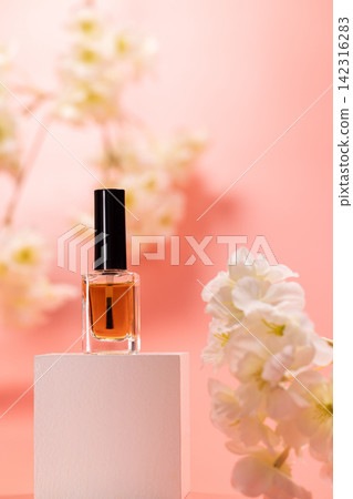 Nail polish bottle standing on podium with flowers Nail polish bottle standing on podium with flowers 142316283