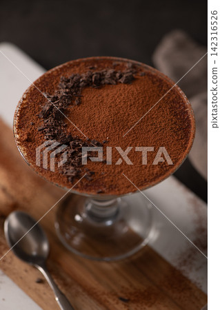 Top Down View of Tiramisu Dessert in a Glass with Cocoa Powder and Chocolate Shavings 142316526