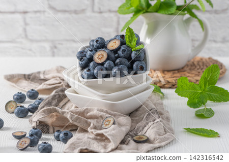 Fresh blueberries in stacked bowls with mint Fresh blueberries in stacked bowls with mint 142316542