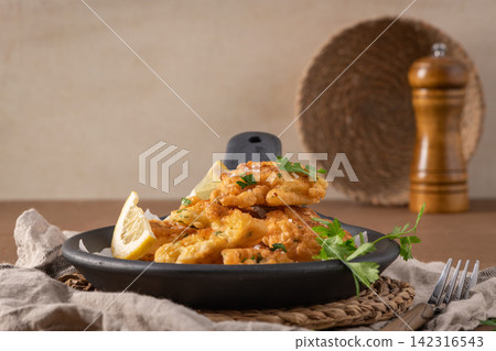 Crispy Cod Fish Fritters Served on a Rustic Ceramic Plate Crispy Cod Fish Fritters Served on a Rustic Ceramic Plate 142316543