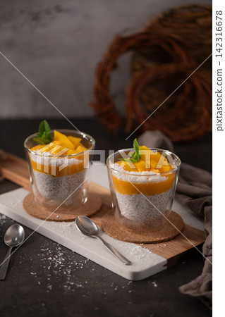 Mango Chia Pudding with Coconut and Mint in Glass Cups Mango Chia Pudding with Coconut and Mint in Glass Cups 142316678