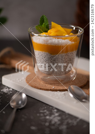 Chia Seed Pudding with Mango Puree and Fresh Mint in a Glass Chia Seed Pudding with Mango Puree and Fresh Mint in a Glass 142316679