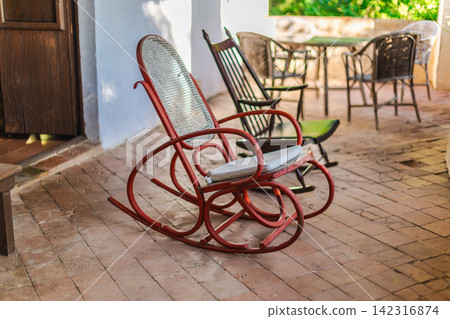 Vintage rocking chair on Mediterranean veranda in historic countryside residence 142316874