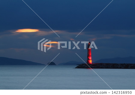 Seascape at sunshine. Lighthouse and sailings on the coast. Seaside town of Turgutreis and spectacular sunshine Seascape at sunshine. Lighthouse and sailings on the coast. Seaside town of Turgutreis and spectacular sunshine 142316950