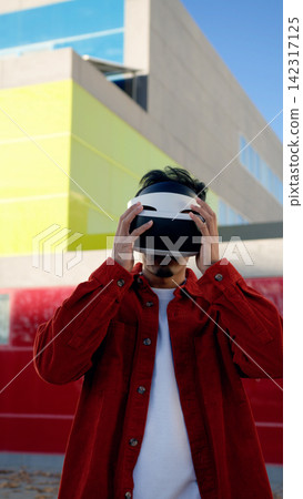 Moroccan man engaging with virtual reality metaverse Moroccan man engaging with virtual reality metaverse 142317125