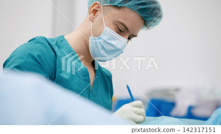 Surgeon making incision during medical procedure in hospital Surgeon making incision during medical procedure in hospital 142317151