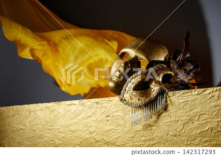 Golden carnival masks on a gold background. Golden carnival masks on a gold background. 142317293
