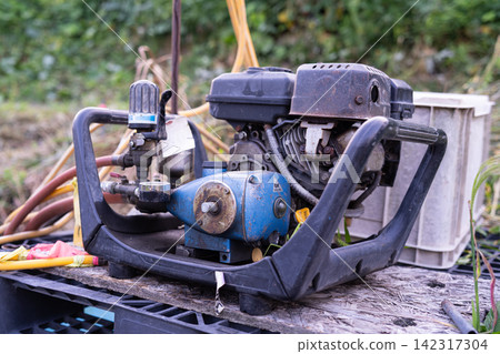 Engine-powered sprayer placed in a field Engine-powered sprayer placed in a field 142317304