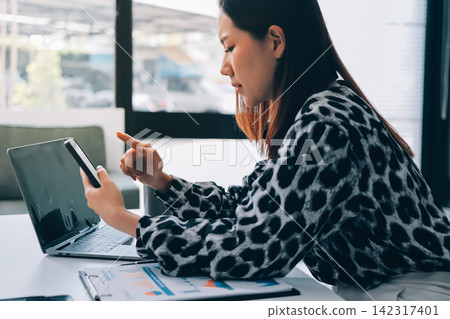 Tried young Asian office employee feeling sick and have a headache from a long working day at office Tried young Asian office employee feeling sick and have a headache from a long working day at office 142317401