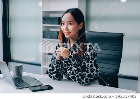 Confident asian business woman standing in modern office Confident asian business woman standing in modern office 142317402
