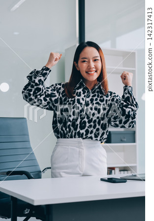 Confident asian business woman standing in modern office Confident asian business woman standing in modern office 142317413