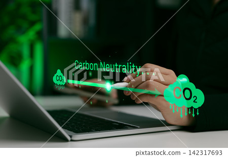 Carbon neutrality concept. Person using laptop with CO2 emission icons and green arrows, representing environmental sustainability, neutral, climate action and net zero carbon footprint strategy. Carbon neutrality concept. Person using laptop with CO2 emission icons and green arrows, representing environmental sustainability, neutral, climate action and net zero carbon footprint strategy. 142317693