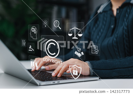 Copyright protection concept. Person using laptop with intellectual property icon representing legal compliance, content ownership rights, digital security, trademark law and creative asset protection Copyright protection concept. Person using laptop with intellectual property icon representing legal compliance, content ownership rights, digital security, trademark law and creative asset protection 142317773