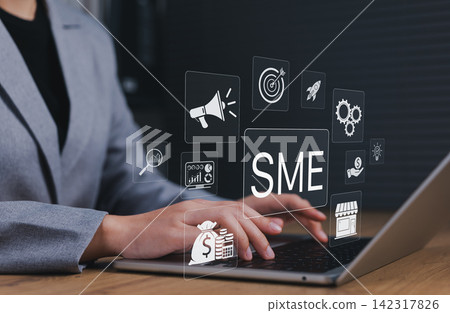 SME small business growth concept. Entrepreneur managing digital marketing strategy, finance, analytics and business development using laptop technology to grow online business and startup operations. SME small business growth concept. Entrepreneur managing digital marketing strategy, finance, analytics and business development using laptop technology to grow online business and startup operations. 142317826
