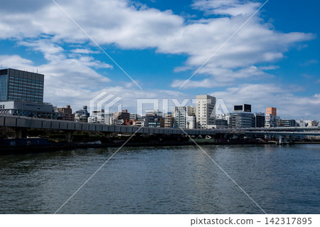 A view of the Sumida River and the Metropolitan Expressway from Kiyosubashi Bridge, with the blue sky stretching across Tokyo's waterfront. A view of the Sumida River and the Metropolitan Expressway from Kiyosubashi Bridge, with the blue sky stretching across Tokyo's waterfront. 142317895