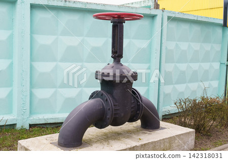 Black Fire Hydrant on Cement Block Black Fire Hydrant on Cement Block 142318031