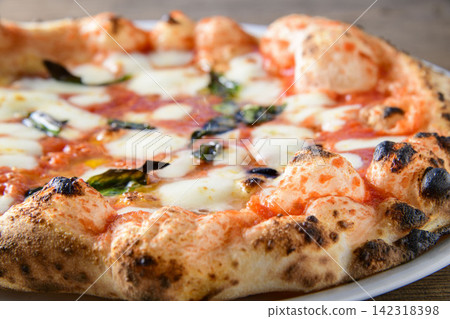 Freshly baked pizza, mozzarella cheese, tomato sauce, and the aroma of basil fill the air. Freshly baked pizza, mozzarella cheese, tomato sauce, and the aroma of basil fill the air. 142318398