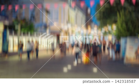 Abstract Blurred Pedestrians on Evening City Street. Defocused pedestrians, illuminated buildings, abstract urban evening. Intentional blur for versatile background of city life, movement, nightlife Abstract Blurred Pedestrians on Evening City Street. Defocused pedestrians, illuminated buildings, abstract urban evening. Intentional blur for versatile background of city life, movement, nightlife 142318587
