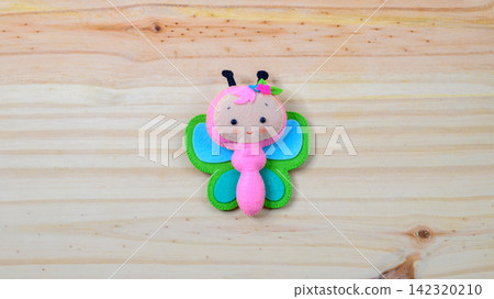 Handmade butterfly sun on a wooden background with copy space Handmade butterfly sun on a wooden background with copy space 142320210