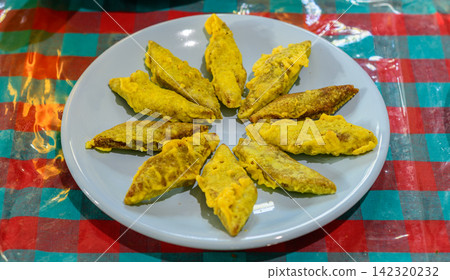 Traditional Sri Lankan New Year mung kavum arranged on a plate for festive celebration Traditional Sri Lankan New Year mung kavum arranged on a plate for festive celebration 142320232