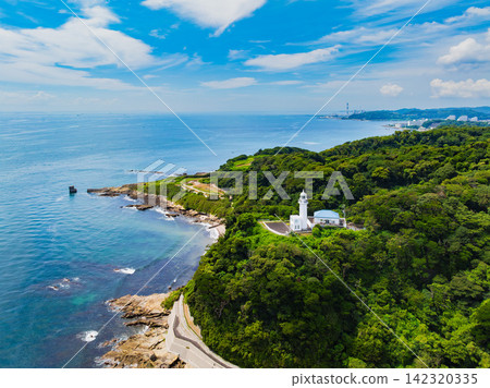 A clear summer morning, aerial photograph of Kannonzaki Lighthouse taken from 145 meters above the sea side of Kannonzaki, with Tokyo Bay in the background. A clear summer morning, aerial photograph of Kannonzaki Lighthouse taken from 145 meters above the sea side of Kannonzaki, with Tokyo Bay in the background. 142320335