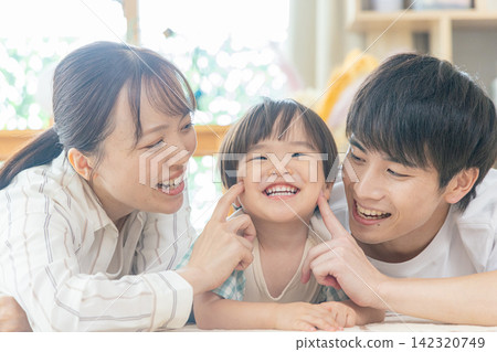 A family relaxing in the living room A family relaxing in the living room 142320749