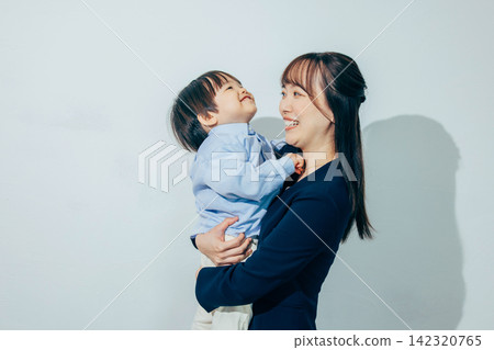 A mother holding a child A mother holding a child 142320765