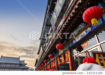 classical Chinese wooden architectural building with traditional tile roof under blue sky classical Chinese wooden architectural building with traditional tile roof under blue sky 142321189