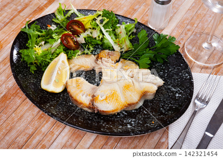 Dish of ocean fish tintorera (Prionace glauca) with lemon and herbs. Dish of ocean fish tintorera (Prionace glauca) with lemon and herbs. 142321454