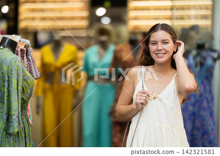 Young woman looks around at street market Young woman looks around at street market 142321581