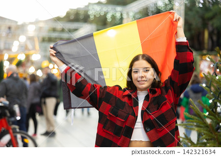 Girl with Belgium flag at new year street fair Girl with Belgium flag at new year street fair 142321634