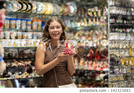 Woman standing in souvenir shop Woman standing in souvenir shop 142321681